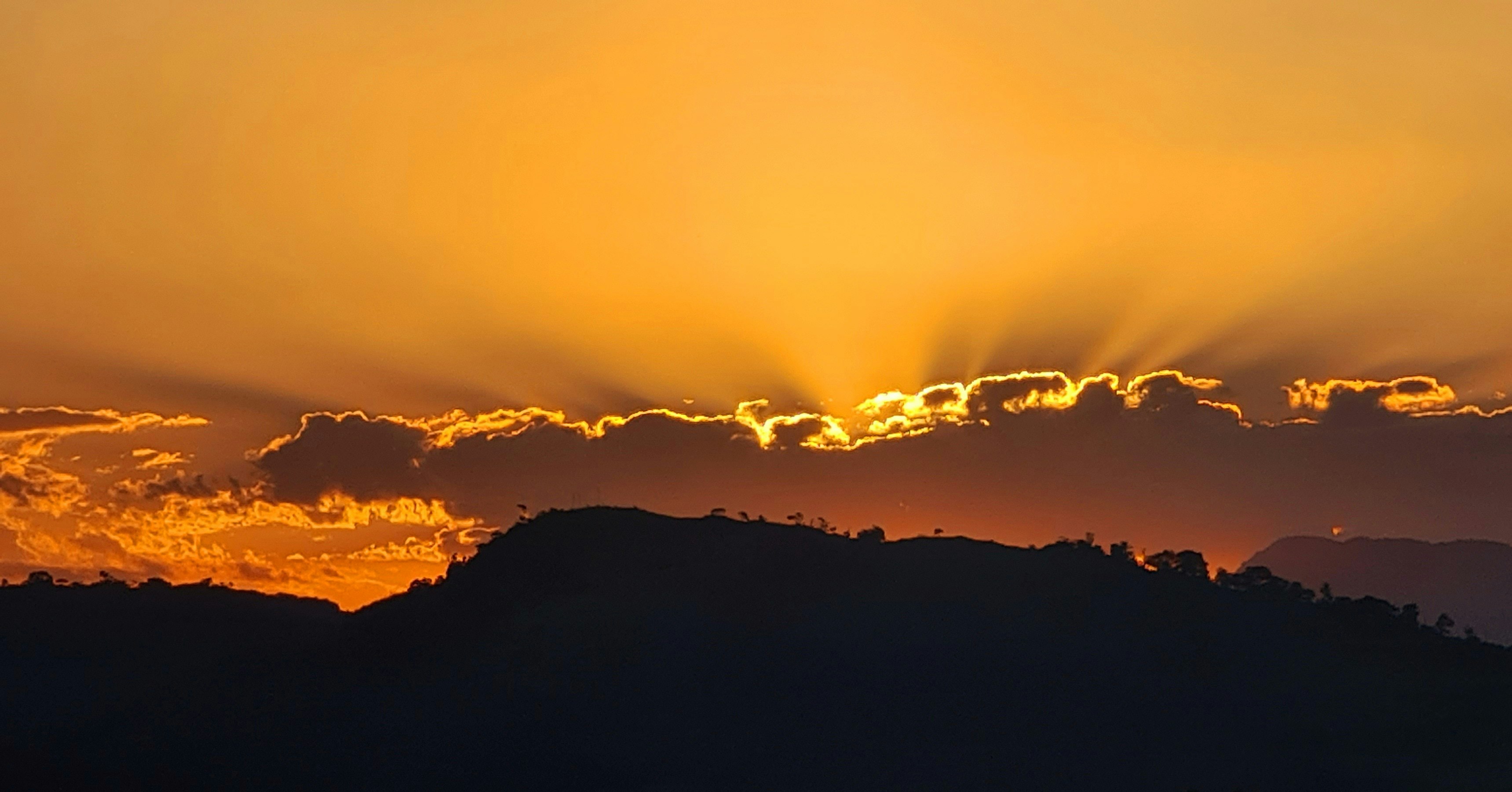 silhouette of mountains during sunset